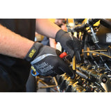 Gloved hands working on a motorcycle engine or mechanical components.
