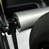 Car spare tire carrier with silver exhaust muffler on Coats ProBalance E900 direct drive wheel balancer