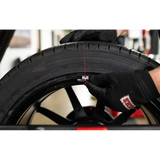 Person adjusting tire weight on Coats ProBalance E900 direct drive wheel balancer