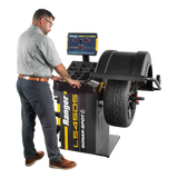 Man using Ranger LS45DS laser wheel balancer with mounted tire for precise balancing
