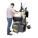 Man using Ranger R980DP tire changer with pneumatic cylinders and dual assist arms