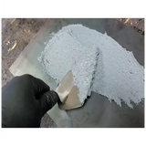 Gray paste being spread with a trowel for Rema 1 Gal Wear Repair Compound w/ Hardener