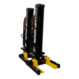 Black vehicle lift with yellow adjustable arms for heavy-duty vehicle maintenance in Rotary MCHM19 Flex Max Mobile Column Lift system