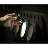 Streamlight 66318 illuminating a dark surface with its compact flashlight beam